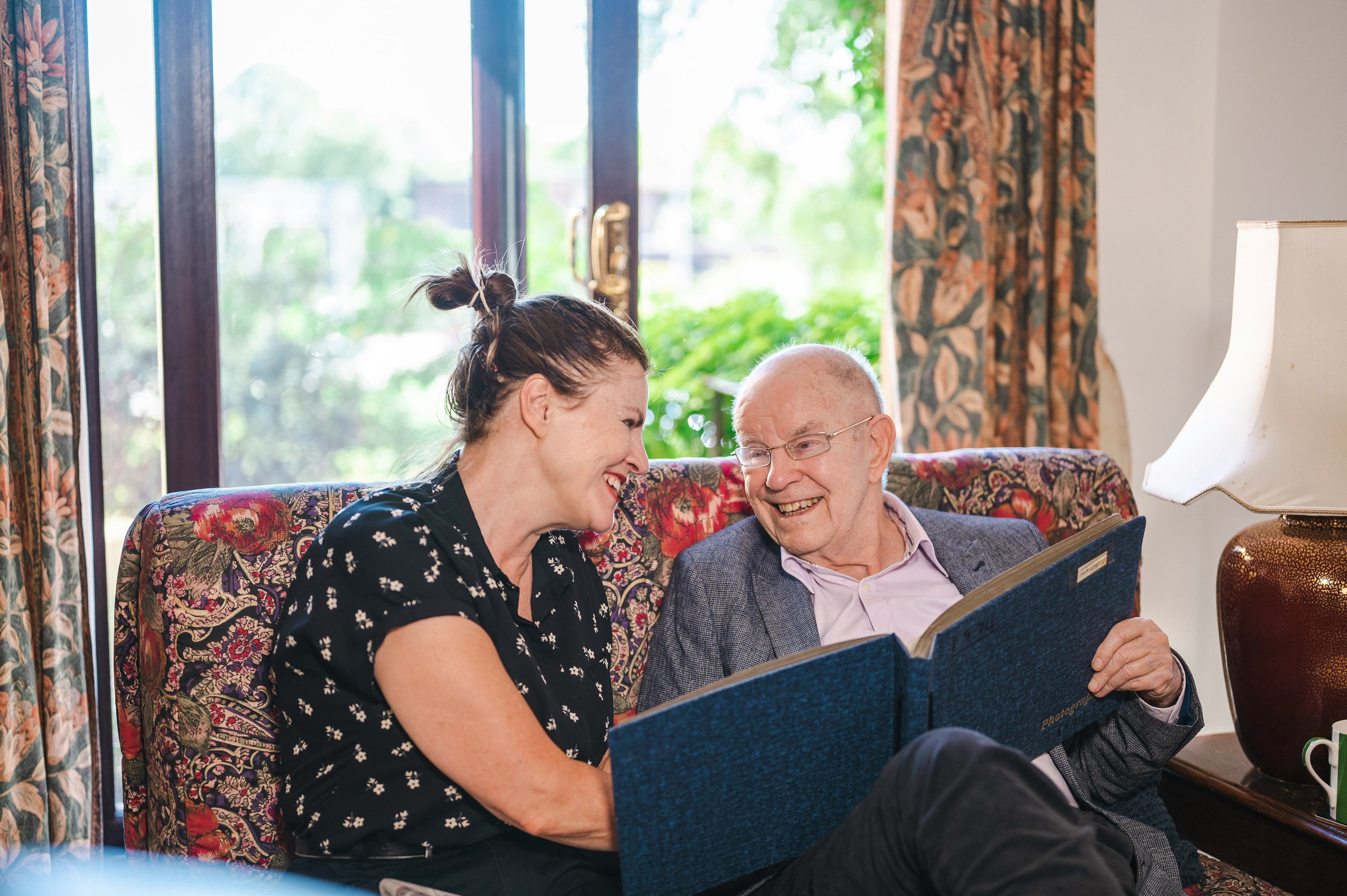 Care professional supporting a client outdoors in the sunshine